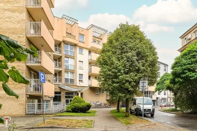 an apartment building with a van parked in front of it at Przestronny Apartament w Krakowie z Biurkiem, Parkingiem i Wanną by Noclegi Renters in Kraków