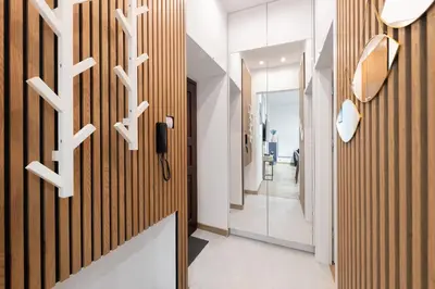 a hallway with wood paneled walls and a door at Apartament Sarego Krakow Center in Kraków