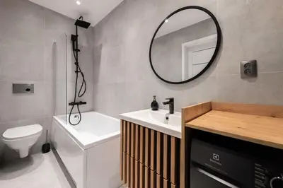 a bathroom with a sink toilet and a mirror at Apartament Sarego Krakow Center in Kraków