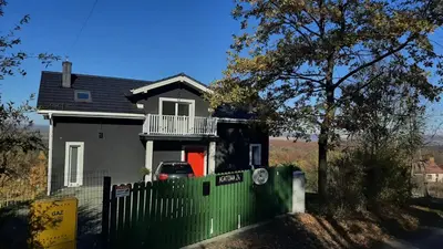 a house with a green fence in front of it at Siedlisko na Agatowej w Rudnie in Rudno