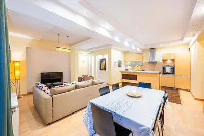a living room with a couch and a table at Nice and specious two bedrooms apartment in the Kraków Old Town in Kraków