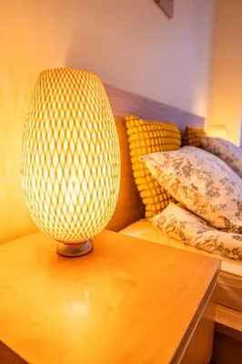 a lamp sitting on a table next to a couch at Nice and specious two bedrooms apartment in the Kraków Old Town in Kraków