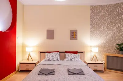 a bedroom with a large bed with two night stands at Nice and specious two bedrooms apartment in the Kraków Old Town in Kraków
