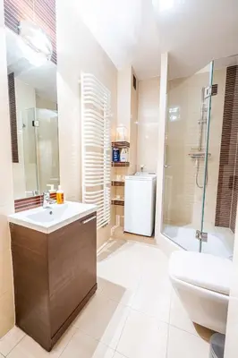 a bathroom with a sink and a shower and a toilet at Nice and specious two bedrooms apartment in the Kraków Old Town in Kraków