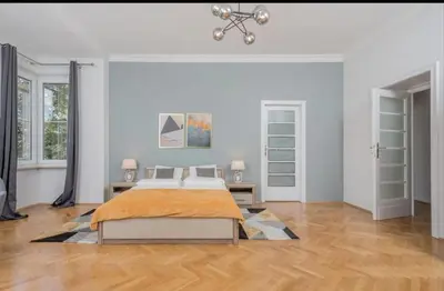 a bedroom with a bed in a white room at Malila Premium Apartments Cracow City Rtm Zbigniewa Dunin Wąsowicza 4 in Kraków