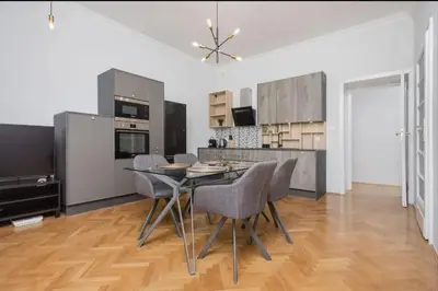 a kitchen with a table and chairs in a room at Malila Premium Apartments Cracow City Rtm Zbigniewa Dunin Wąsowicza 4 in Kraków