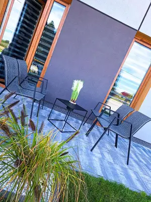 a group of chairs and tables on a patio at Zatorski Apartament na Jaśminowej in Zator