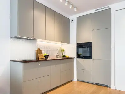 a kitchen with white cabinets and a sink at Klimeckiego Luxury Apartments 189 in Kraków