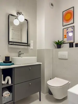 a bathroom with a sink and a toilet and a mirror at Klimeckiego Luxury Apartments 189 in Kraków