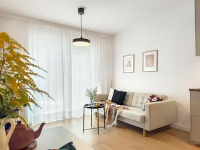 a living room with a couch and a table at Klimeckiego Luxury Apartments 189 in Kraków
