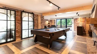 a pool table in a room with brick walls at Villa na pagórku Limanowa in Mordarka