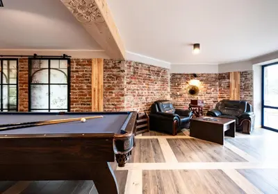 a pool table in a room with a brick wall at Villa na pagórku Limanowa in Mordarka