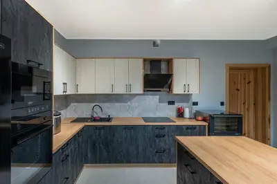 a kitchen with wooden cabinets and a counter top at Villa na pagórku Limanowa in Mordarka