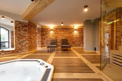 a room with a bath tub and a brick wall at Villa na pagórku Limanowa in Mordarka