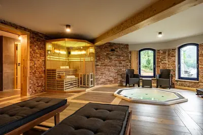 a living room with a hot tub in a brick wall at Villa na pagórku Limanowa in Mordarka