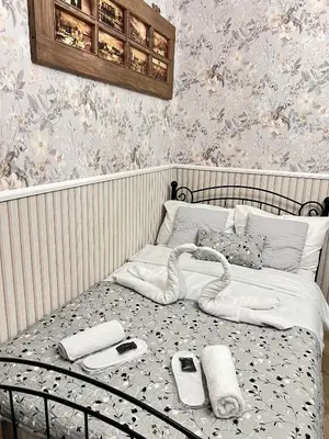 a bed with cell phones and other items on it at Antique apartment in Krakow in Kraków