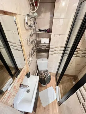 a small bathroom with a sink and a toilet at Antique apartment in Krakow in Kraków