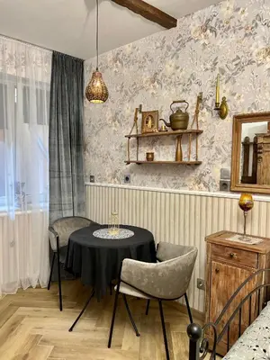 a dining room with a table and two chairs at Antique apartment in Krakow in Kraków