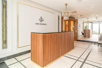 a lobby with a reception desk in a building at Kraków Libra Apartment - AC - by Rentujemy in Kraków