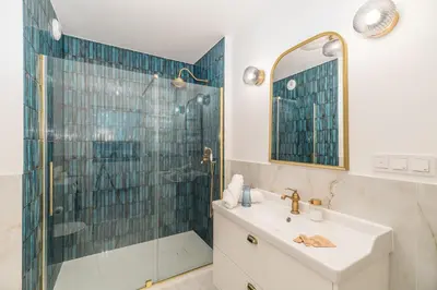 a bathroom with a shower and a sink and a mirror at Kraków Libra Apartment - AC - by Rentujemy in Kraków