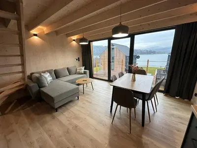 a living room with a couch and a table at Mucharskie Zacisze in Zagórze