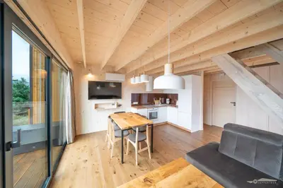 a small kitchen and dining room in a tiny house at Mucharskie Zacisze in Zagórze