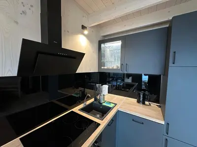 a kitchen with a sink and a counter top at Mucharskie Zacisze in Zagórze