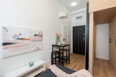 a room with a bed and a painting on the wall at Smart Studio 5 in Kraków