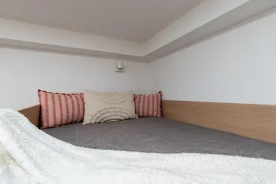 a bed with two pillows in a room at Smart Studio 5 in Kraków