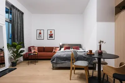 a bedroom with a bed and a couch and a table at D21 Art Vintage Old Town in Kraków