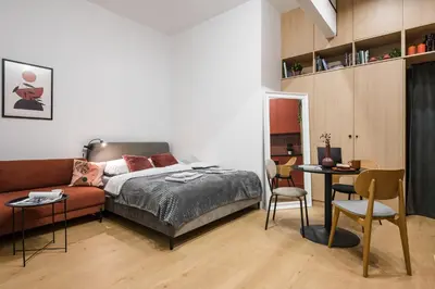 a bedroom with a bed and a couch and a table at D21 Art Vintage Old Town in Kraków