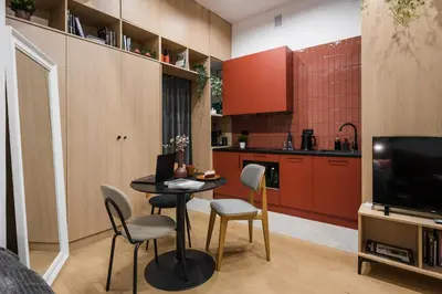 a living room with a table and chairs and a kitchen at D21 Art Vintage Old Town in Kraków