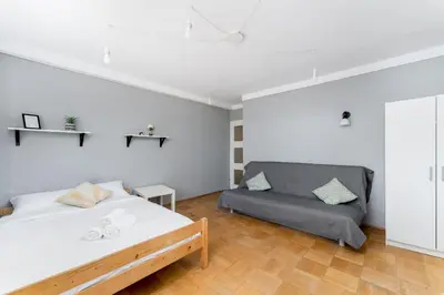 a bedroom with a bed and a couch at Park Zakrzówek Spacious Apartment by BookingHost in Kraków