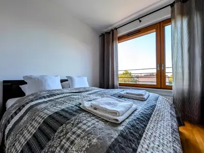 a bedroom with a bed with towels on it at Masarska 9 by Homeprime in Kraków