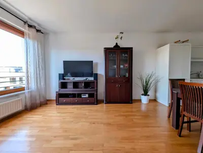a living room with a television and a cabinet at Masarska 9 by Homeprime in Kraków