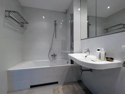 a white bathroom with a sink and a bath tub at Masarska 9 by Homeprime in Kraków