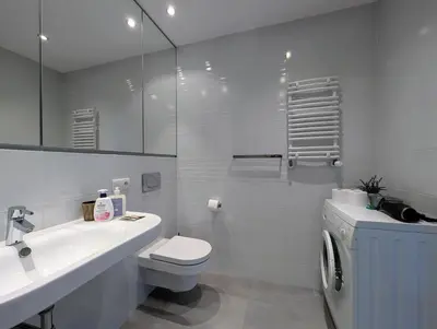 a white bathroom with a toilet and a sink at Masarska 9 by Homeprime in Kraków