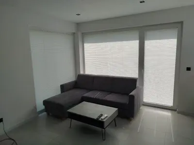 a living room with a couch and a coffee table at Domek Całoroczny in Stróża