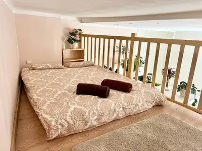 a bedroom with a bed with two pillows on it at Nowoczesny Apartament w Centrum Krakowa in Kraków