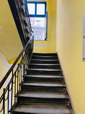 a stair case in a building with a window at Nowoczesny Apartament w Centrum Krakowa in Kraków