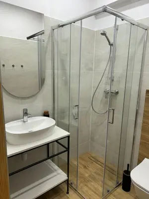 a bathroom with a sink and a shower at Juli Apart in Kraków