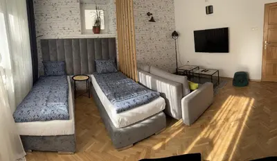 a hallway with a room with a bed at Juli Apart in Kraków