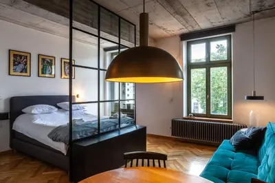 a bedroom with a bed and a table in a room at Charming Loft in the Old Town in Kraków