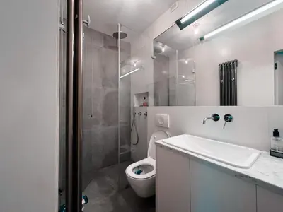 a bathroom with a shower and a toilet and a sink at Charming Loft in the Old Town in Kraków