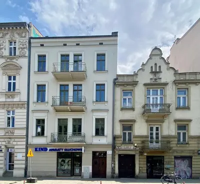 a large white building on a city street at Charming Loft in the Old Town in Kraków