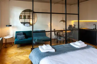 a room with a bed and a couch and a table at Charming Loft in the Old Town in Kraków