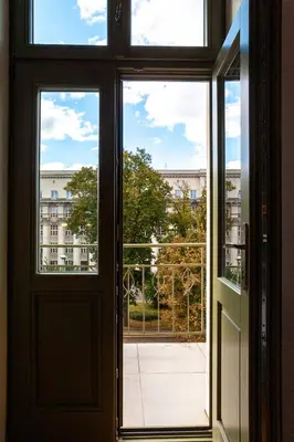 an open door with a view of a building at Charming Loft in the Old Town in Kraków