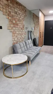 a living room with a couch and a coffee table at Your time in Heart of Cracow , Gym & free parking in Kraków