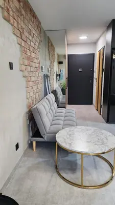 a living room with a couch and a table at Your time in Heart of Cracow , Gym & free parking in Kraków