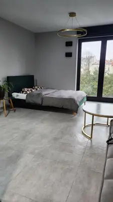 a bedroom with a bed and a large window at Your time in Heart of Cracow , Gym & free parking in Kraków